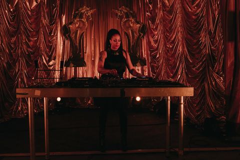 A DJ performs between two giant golden unicorn sculptures at the Golden Unicorn Awards 2019