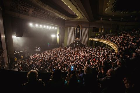 Yury Shevchuk on stage at the Eventim Apollo, facing a packed auditorium lit by thousands of phone lights