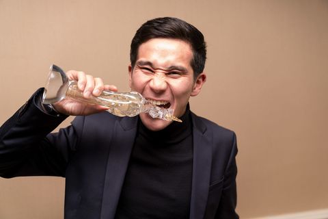 A winner puts his glass unicorn to the test