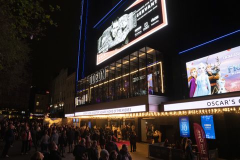 The ODEON Luxe Leicester Square at night, its billboard dressed for a Russian Film Week gala premiere, crowds on the red carpet below